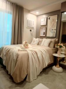 a bedroom with a large bed with a blanket on it at Le Menda Residences - Majestic Heights in Cebu City