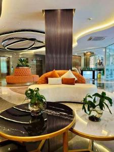 a living room with a couch and two tables at Le Menda Residences - Majestic Heights in Cebu City