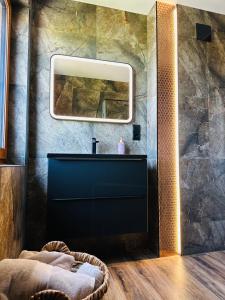 a bathroom with a black sink and a mirror at Apartamenty 1000m npm Murzasichle in Murzasichle +16 photos