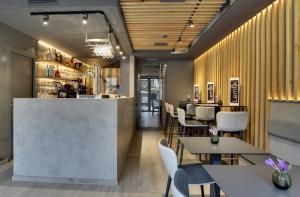 a restaurant with tables and chairs and a bar at Hotel Lemik in Alsasua