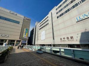 a large building with people walking in front of it at Senjushuku FUJI 101 北千住 in Tokyo +56 photos