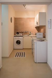 a kitchen with a washer and dryer in it at Paphos Love Shack apartment in Paphos City