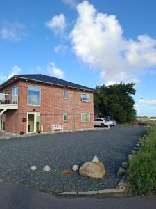 a house with a rock in the middle of a driveway at Villa-Amby in Ringkøbing