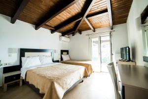 Postel nebo postele na pokoji v ubytování Hotel Dellis