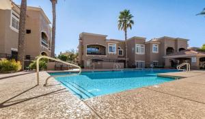 a swimming pool in front of a house at TPC Golf Course North Scottsdale in Scottsdale