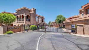 a house with a gate in front of a driveway at TPC Golf Course North Scottsdale in Scottsdale