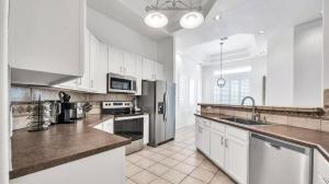 a kitchen with white cabinets and stainless steel appliances at TPC Golf Course North Scottsdale in Scottsdale