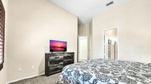 a bedroom with a bed and a flat screen tv at TPC Golf Course North Scottsdale in Scottsdale