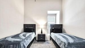 two twin beds in a room with a window at TPC Golf Course North Scottsdale in Scottsdale +13 photos