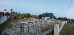 an iron fence in front of a house at Homestay Singgah Tok Dir in Kuala Terengganu