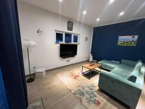 a living room with a couch and a tv at Lushoto Loria in Lushoto