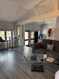 a living room with a couch and a glass table at Lower Barn in Lapford