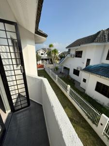 an open door of a white house with a fence at RZ Semi D Homestay in Kelebang Besar
