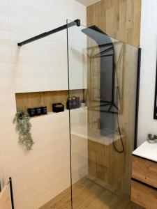 a glass shower stall with a television in it at Apartament Anna De Lux z dużym tarasem in Zamość +47 photos