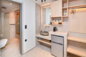 a bathroom with a sink and a toilet at Thrive in Sarti +168 photos