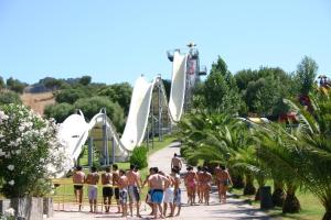 a group of men in bathing suits walking on a roller coaster at Villa Sonia in Maddalenedda
