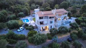 an aerial view of a house with a car parked in front at Avgi Villa & Avra House With Shared Pool by Filoxenia Villas in Corfu