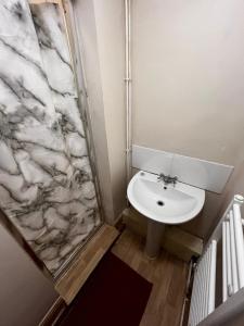 a bathroom with a sink and a shower at close to stadium and the beach 2 bed groundfloor,sky Netflix in Grimsby