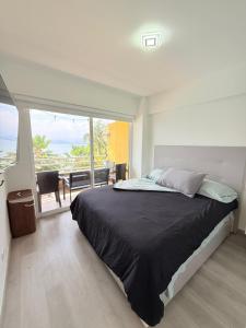 a bedroom with a bed with a view of the ocean at Premium Lecheria - Oceanfront, Pool & Relax in Morro de Barcelona
