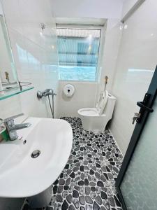 a white bathroom with a sink and a toilet at Aloha farm in Namban +12 photos
