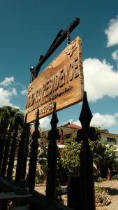 a wooden sign on a black fence at 'Ataongo Residence - Boutique Island Stay, Central Nuku'alofa in Nuku‘alofa