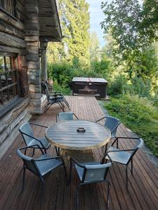 a wooden deck with a table and chairs on it at Villa Lilja in Muurame