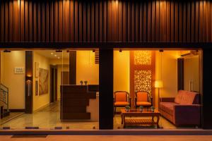 a living room with a couch and a table at Hajiyar Residency in Rāmanāthapuram