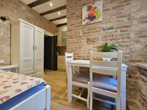 a small kitchen with a table and chairs in a room at Patrik Patrik in Kotor