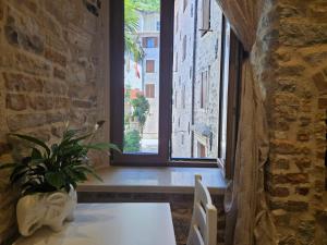 a dining room with a table and a window at Patrik Patrik in Kotor