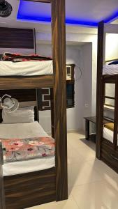 a room with three bunk beds in a room at Anaya Guest House Etah in Etah
