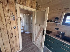a wooden room with a door open to a bathroom at Pokoje Gościnne Nad Jeziorem in Rajgród +48 photos
