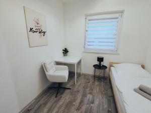 a bedroom with a bed and a desk and a chair at 3 Zimmer Wohnung in Altendorf in Altendorf