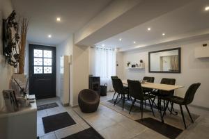 a dining room and living room with a table and chairs at LE CLOS Porte Serrure in Sancerre