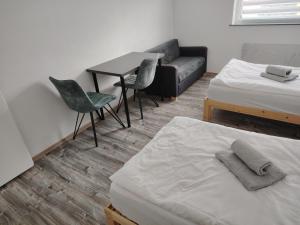 a room with two beds and a couch and a table at 3 Zimmer Wohnung in Altendorf in Altendorf