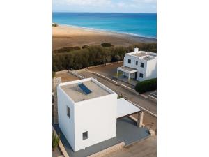 拉卡尼亚Villa Solmar Rhodes的享有白色房子的空中景色,海滩位于后面