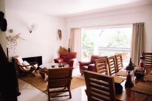 a living room with a table and chairs at SOUTH HILL VILLA in Mahe