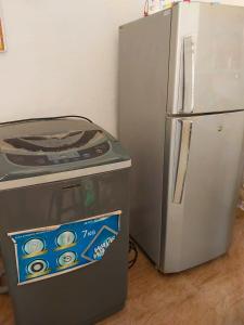 a small refrigerator next to a stove at Abhi Villa in Beruwala