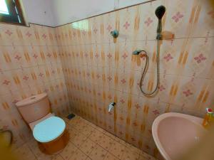 a bathroom with a shower and a toilet and a sink at Abhi Villa in Beruwala