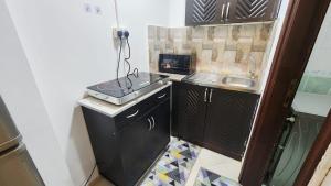 a small kitchen with a sink and a counter at Family Room in Abu Dhabi +3 photos