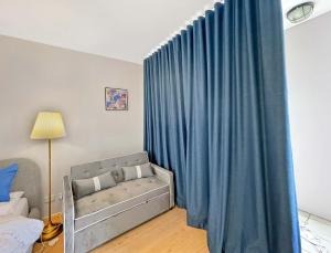 a bedroom with a bed and a blue curtain at MetaWise 1Bed Next to ICC Darling Harbour 154 in Sydney