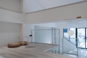 a white room with a staircase and a table at 8 hundred million in Anping