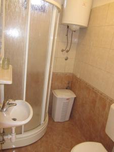 a bathroom with a shower and a toilet and a sink at Apartments Zatezalo A4+2 in Omišalj