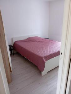 La Celle-sous-GouzonにあるMaison 1- entre ville et verdureのベッドルーム(紫色の掛け布団付きのベッド1台付)