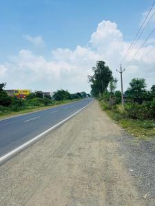 an empty road in the middle of a field at Hotel Sanskar in Dodi