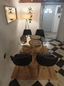 a table and chairs in a room with a mirror at Frida' s Mansion in Dhragoulás