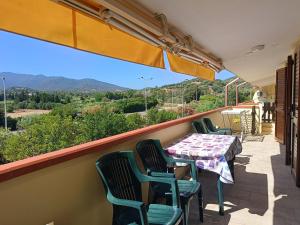 a balcony with a table and chairs and a view at Appartamento Luisa E in Villasimius