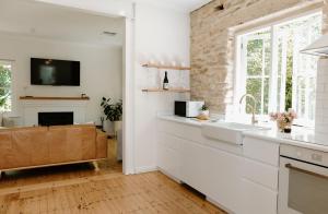 a kitchen with a sink and a fireplace at Stone Gate Cottage in Aldgate