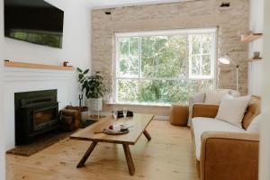 a living room with a couch and a coffee table at Stone Gate Cottage in Aldgate