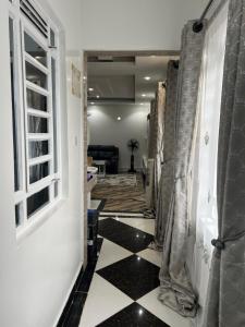 a hallway with a black and white checkered floor at Cnc bnb Kimana- 3bedroom in Gatunga +2 photos