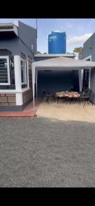 a patio with chairs and a table in front of a building at Cnc bnb Kimana- 3bedroom in Gatunga